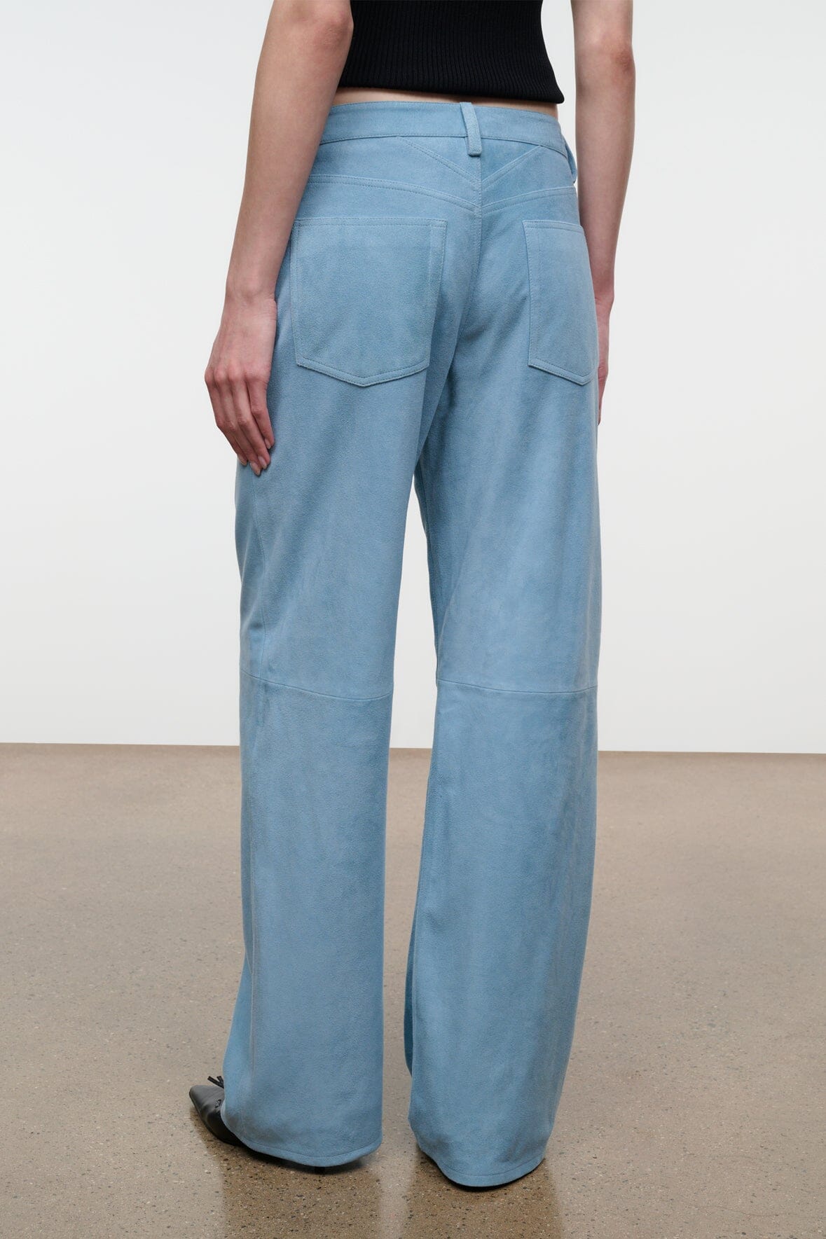 Sky blue suede wide-leg pants with belt loops and front slash pockets.