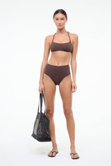 Dark chocolate halter bikini top with red bead trim, front view on model