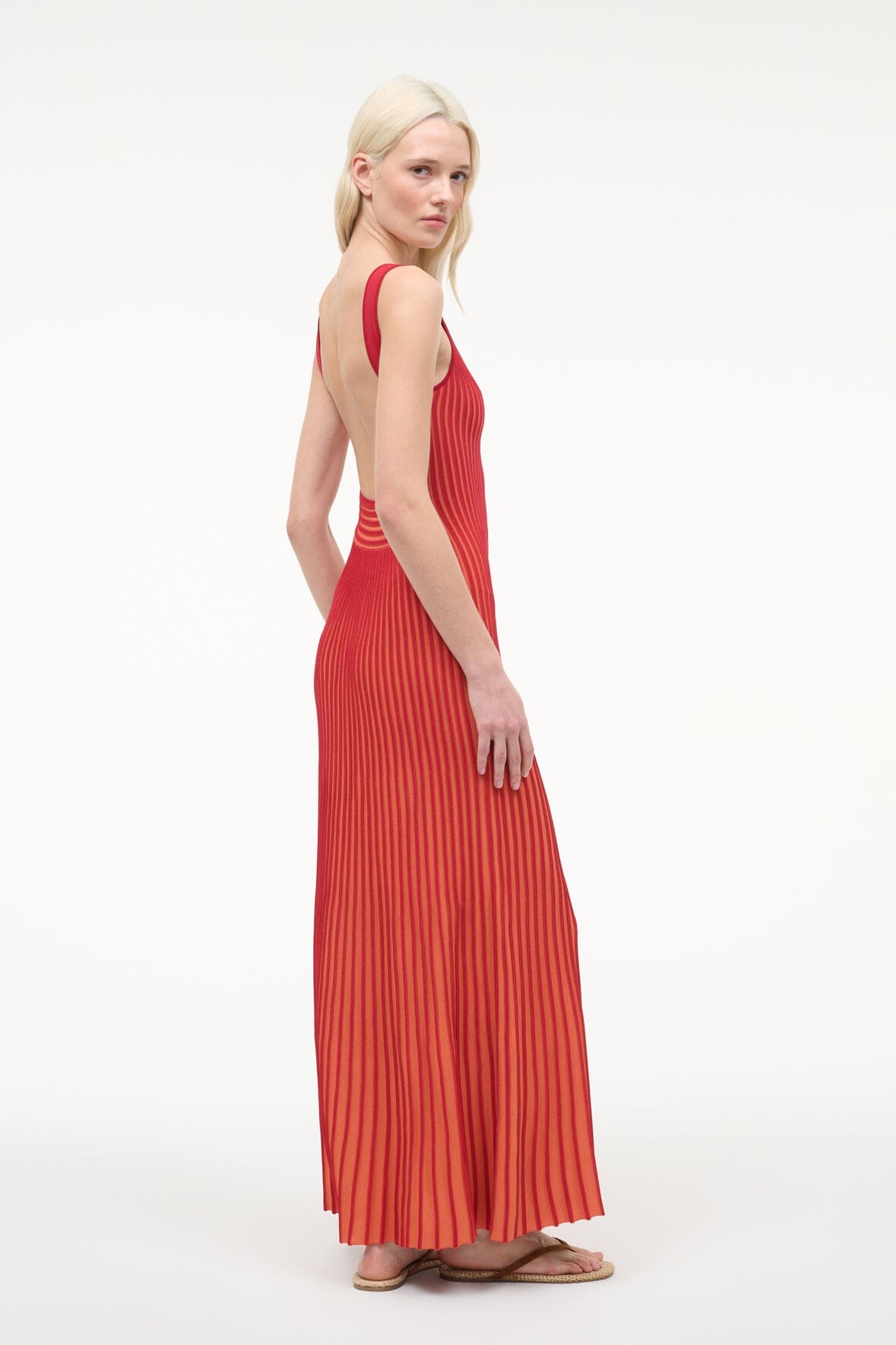 Red pleated sleeveless maxi dress with V-neck and vertical stripe pleats