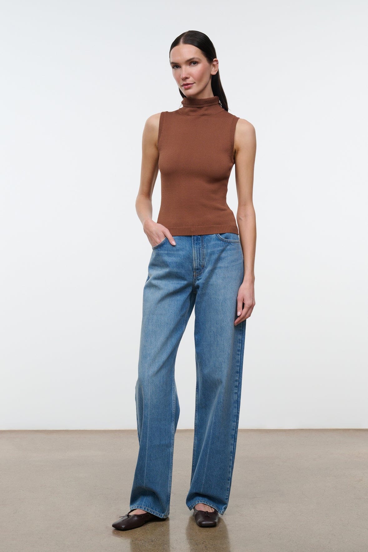 Brown sleeveless mock-neck knit top with ribbed texture, full-length view