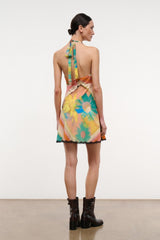 Back view of multicolor sleeveless mini dress with black lace trim and tie straps