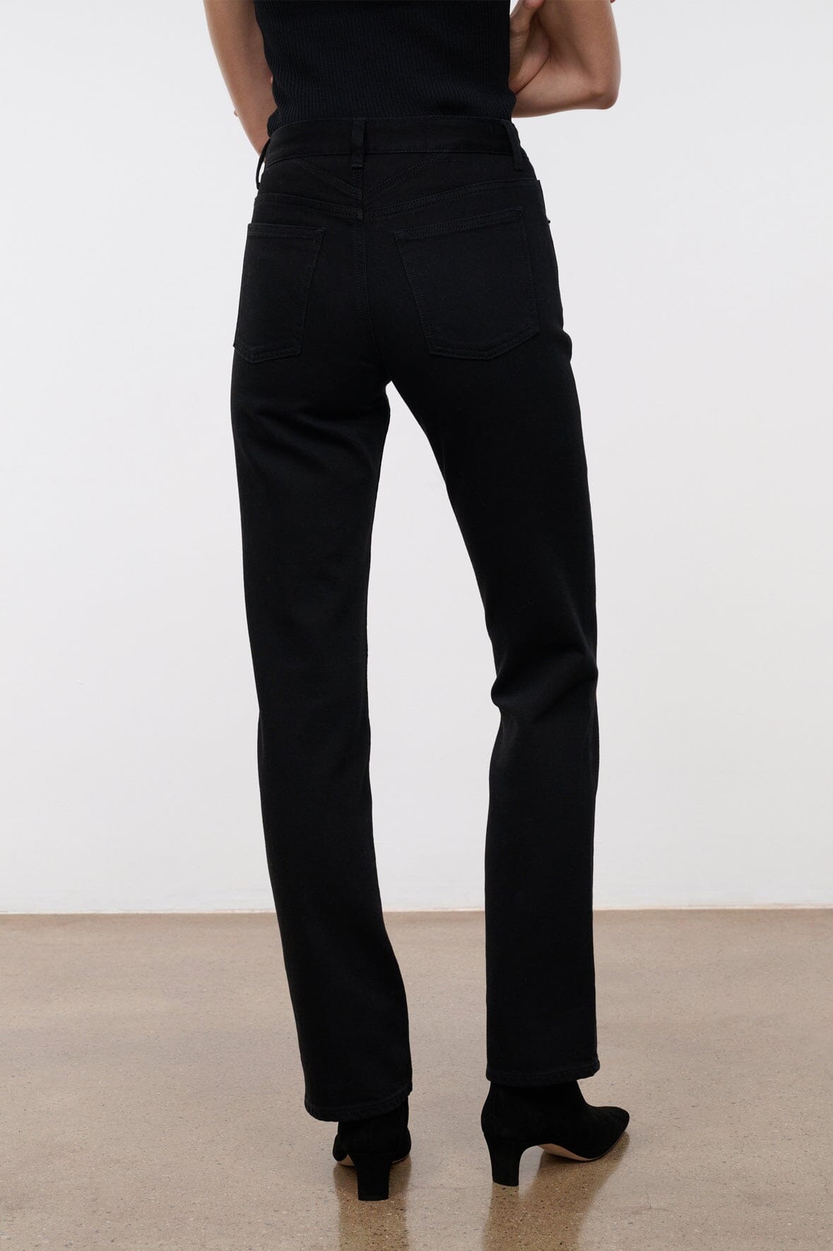 Black straight-leg jeans with back pockets and slim, tapered ankle hem