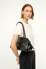 Black leather-look shoulder bag with rounded top and front knot detail