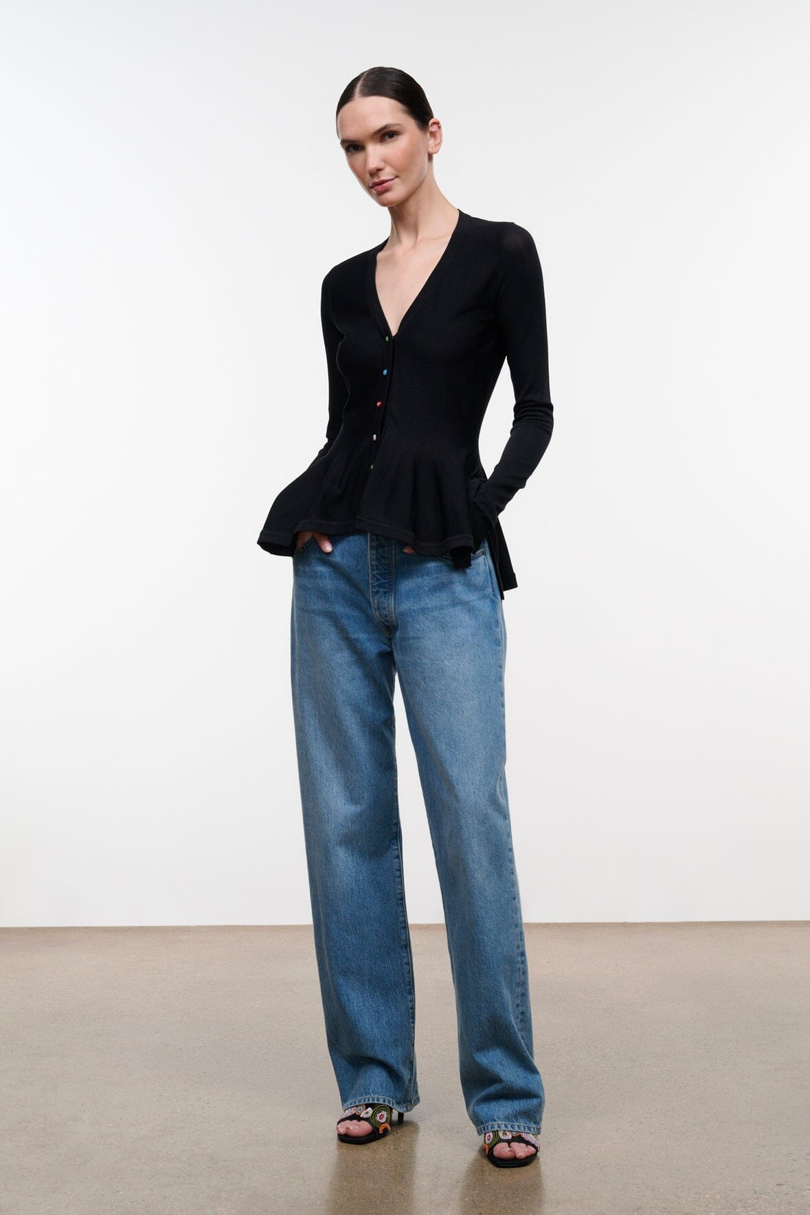 Black long-sleeve V-neck peplum top with button front