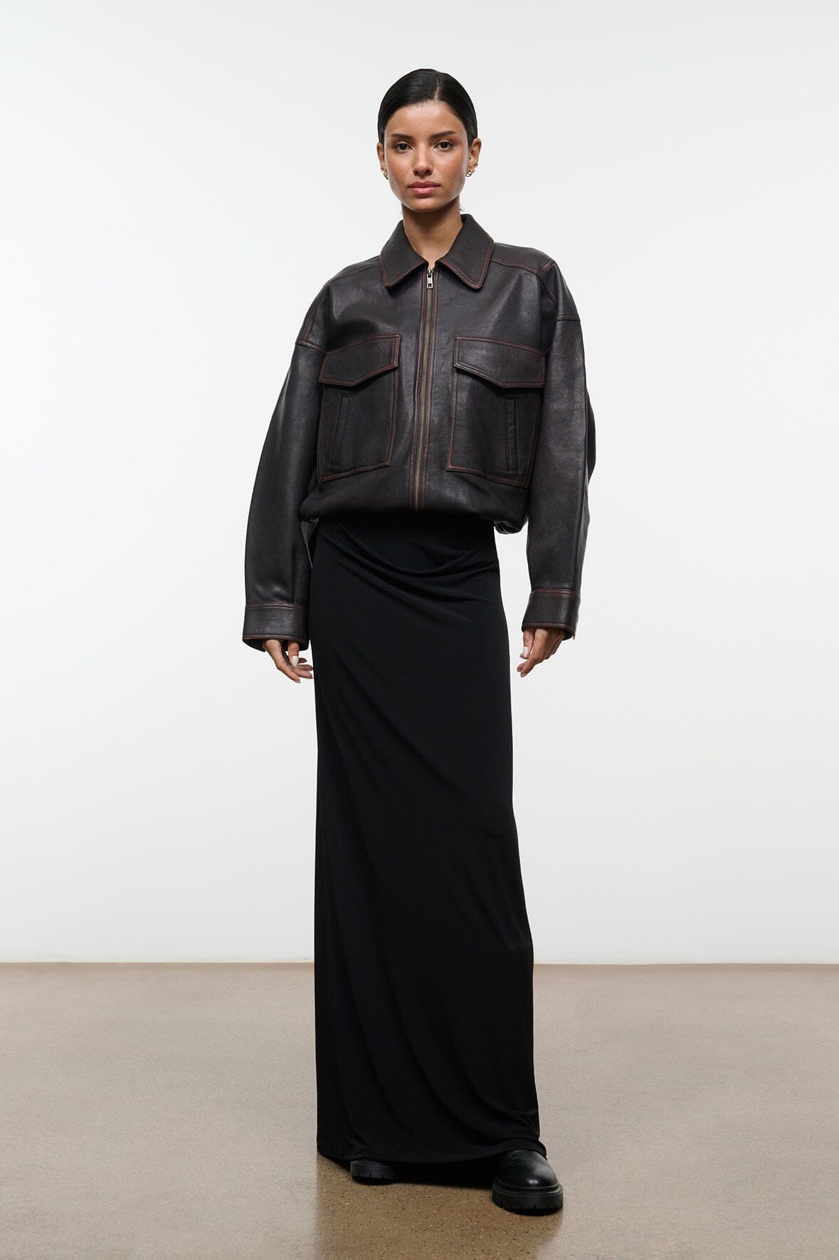 Distressed brown leather jacket with stand collar, zip front, and flap chest pockets