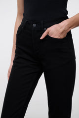 Close-up of black denim jeans waistband with button and belt loops