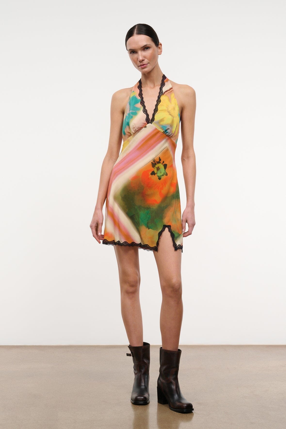 Front view of multicolor sleeveless mini dress with black lace trim and V-neck