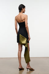 Back view: strapless black mini dress with olive-gold drape and pocket-like fold