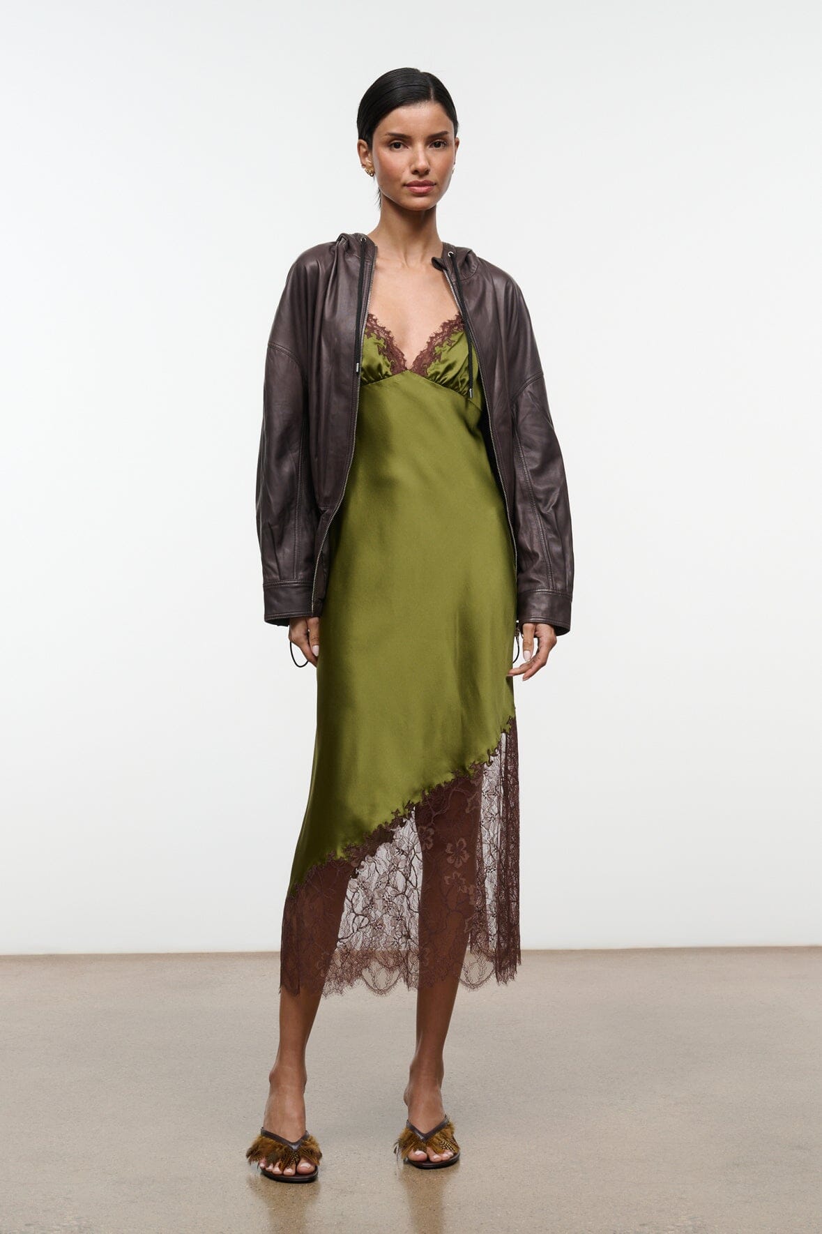 Silk slip dress in pear green with brown lace trim along neckline and hem