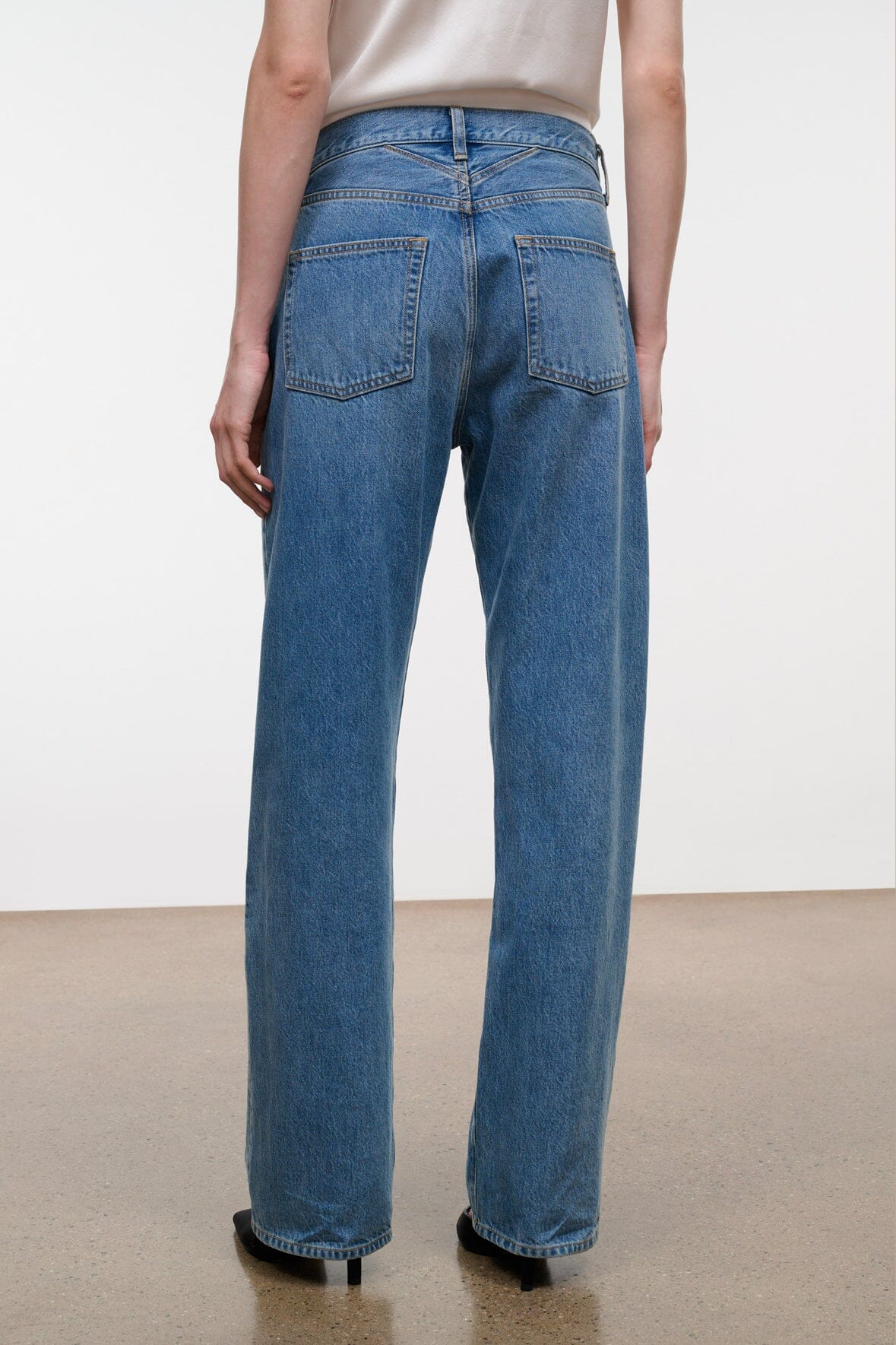 Medium-wash boyfriend jeans with two back patch pockets and belt loops