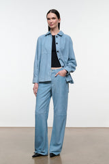 Sky-blue suede shirt with point collar and black buttons; relaxed fit, long sleeves