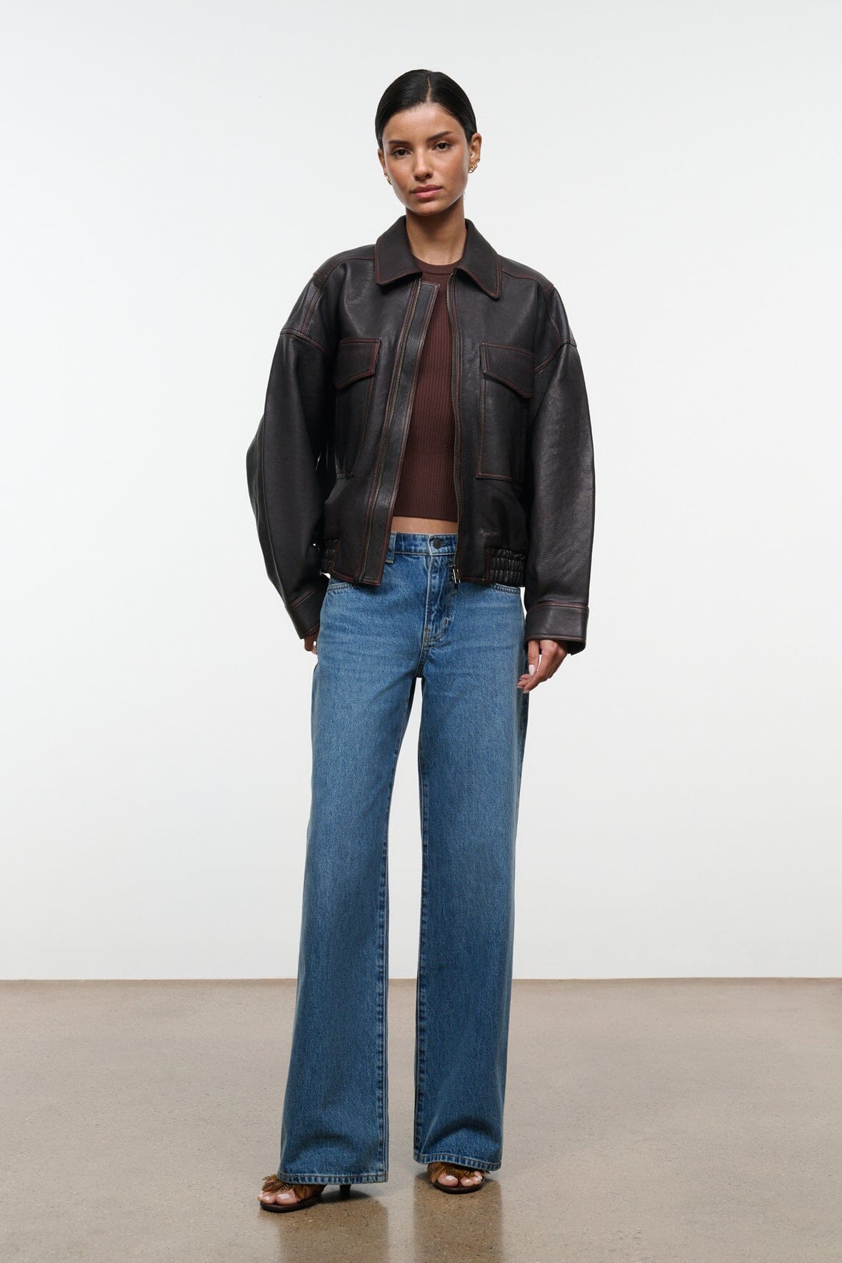 Distressed brown leather zip jacket with flap pockets and ribbed waistband