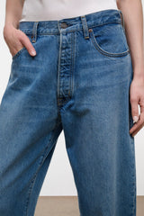 Medium-wash boyfriend jeans with button waist, belt loops, and five pockets