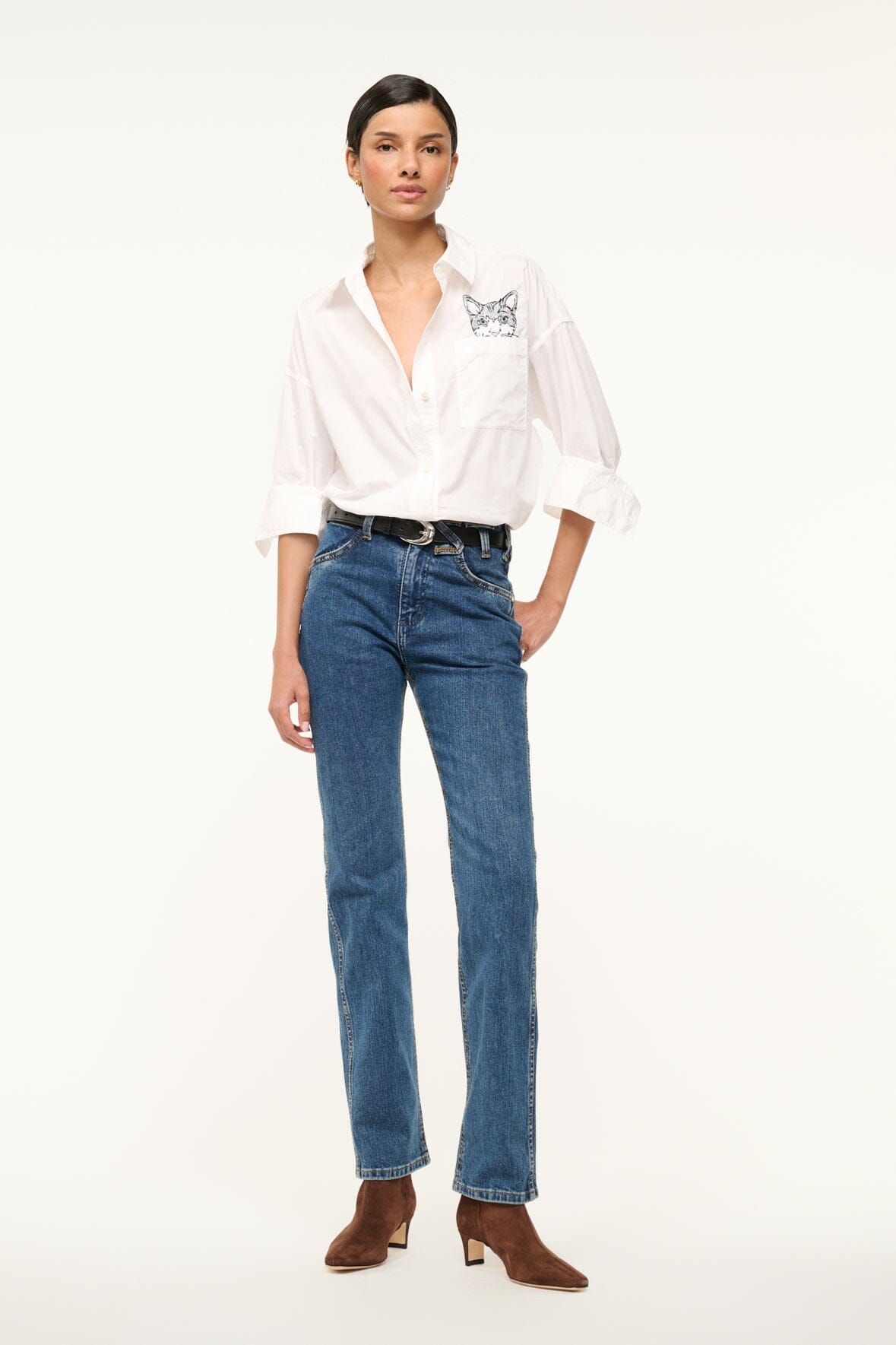 White oversized button-up shirt with chest pocket and cat graphic patch