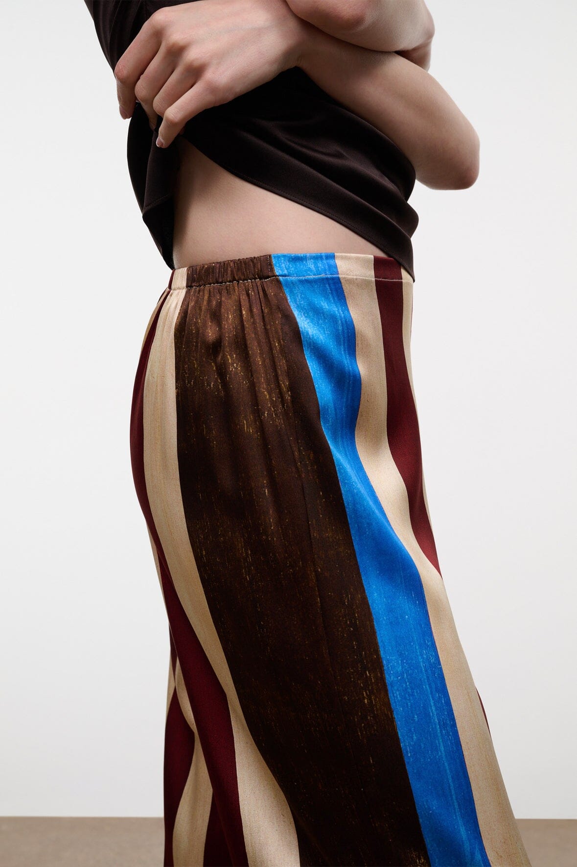 Silk striped pants close-up with elastic waist and blue side panel