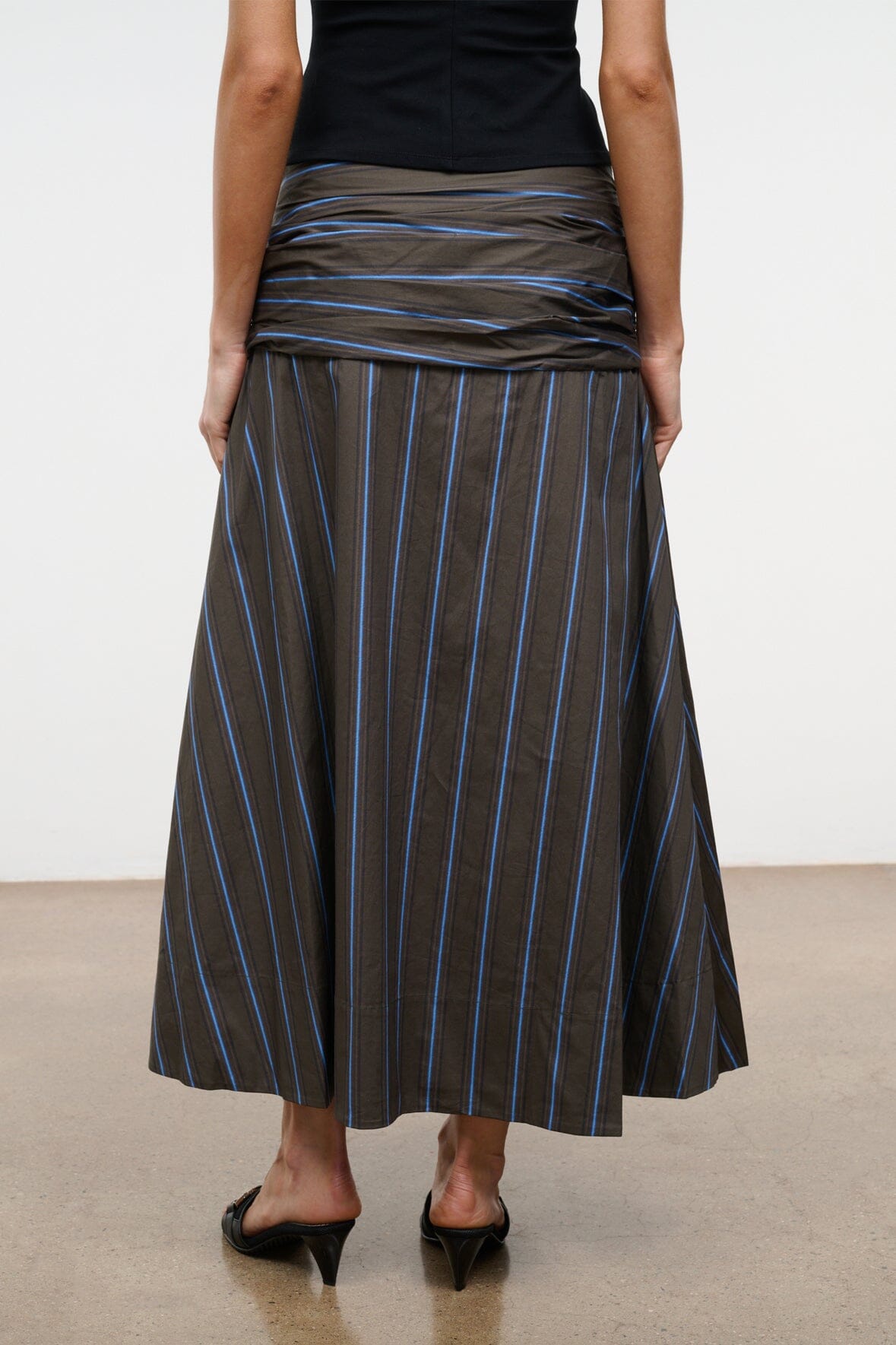 SOL striped midi skirt with vertical blue and tan stripes on dark fabric, A-line hem