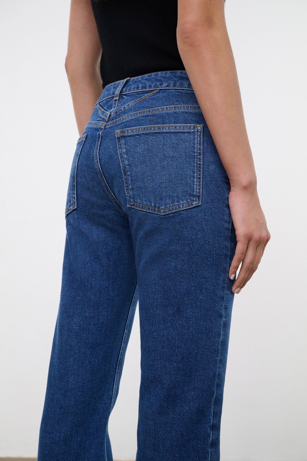Stone blue denim jeans back pocket and waistband stitching detail