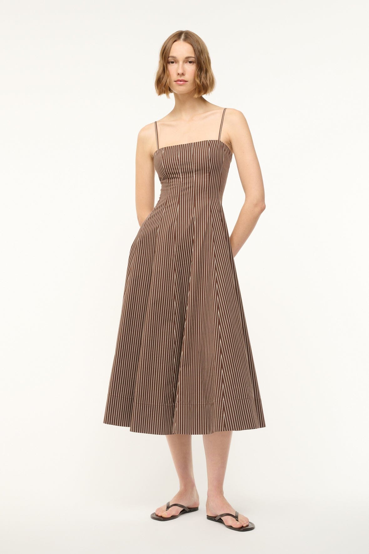 Dark brown micro-striped dress with spaghetti straps and flared skirt