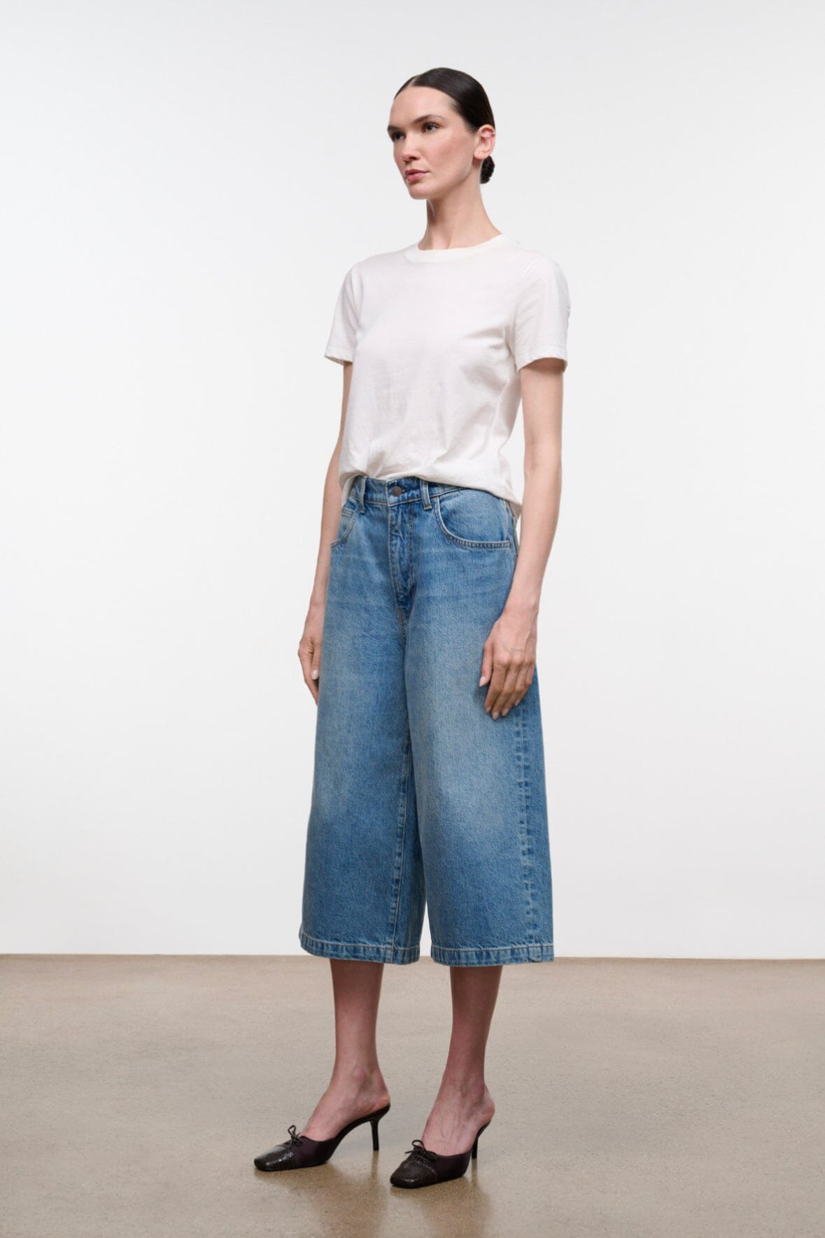 Light blue denim culotte jeans with mid-rise waist and stitched front pockets
