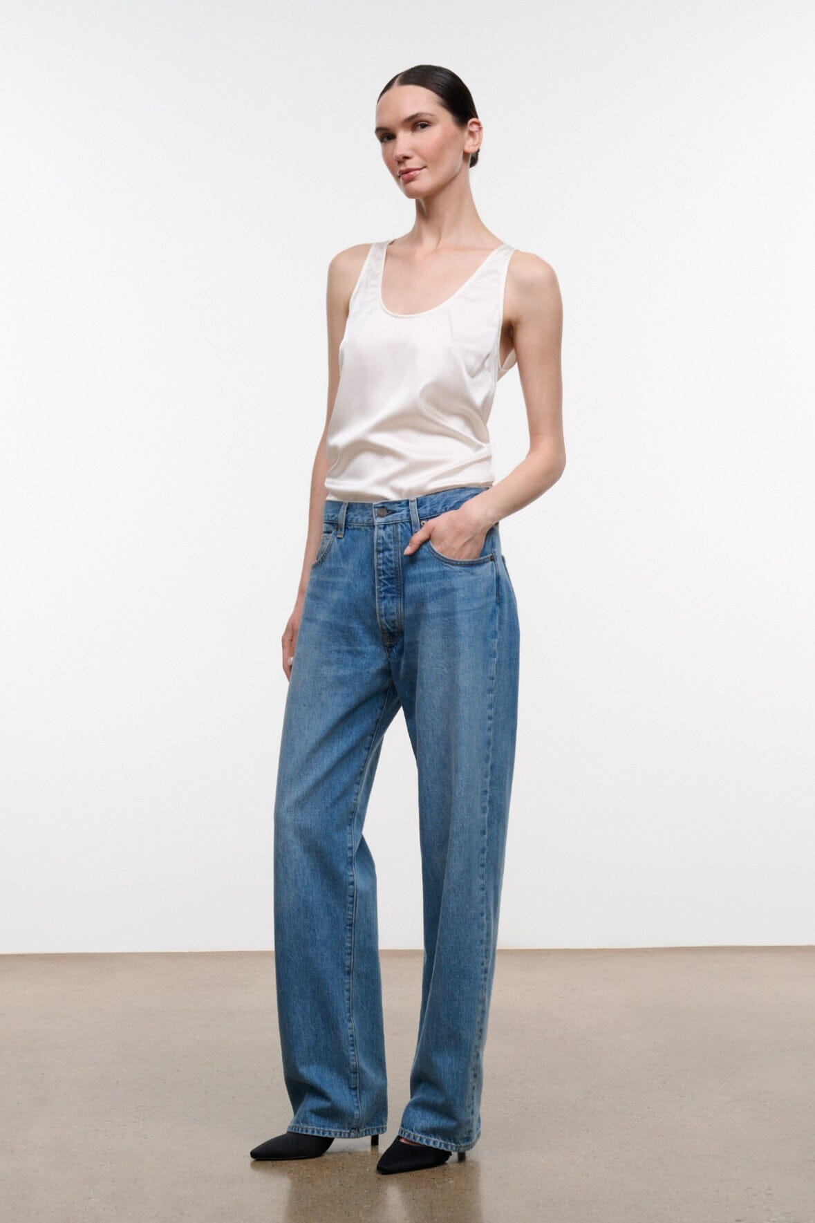 Medium-wash boyfriend jeans with wide legs, button waist, and five pockets