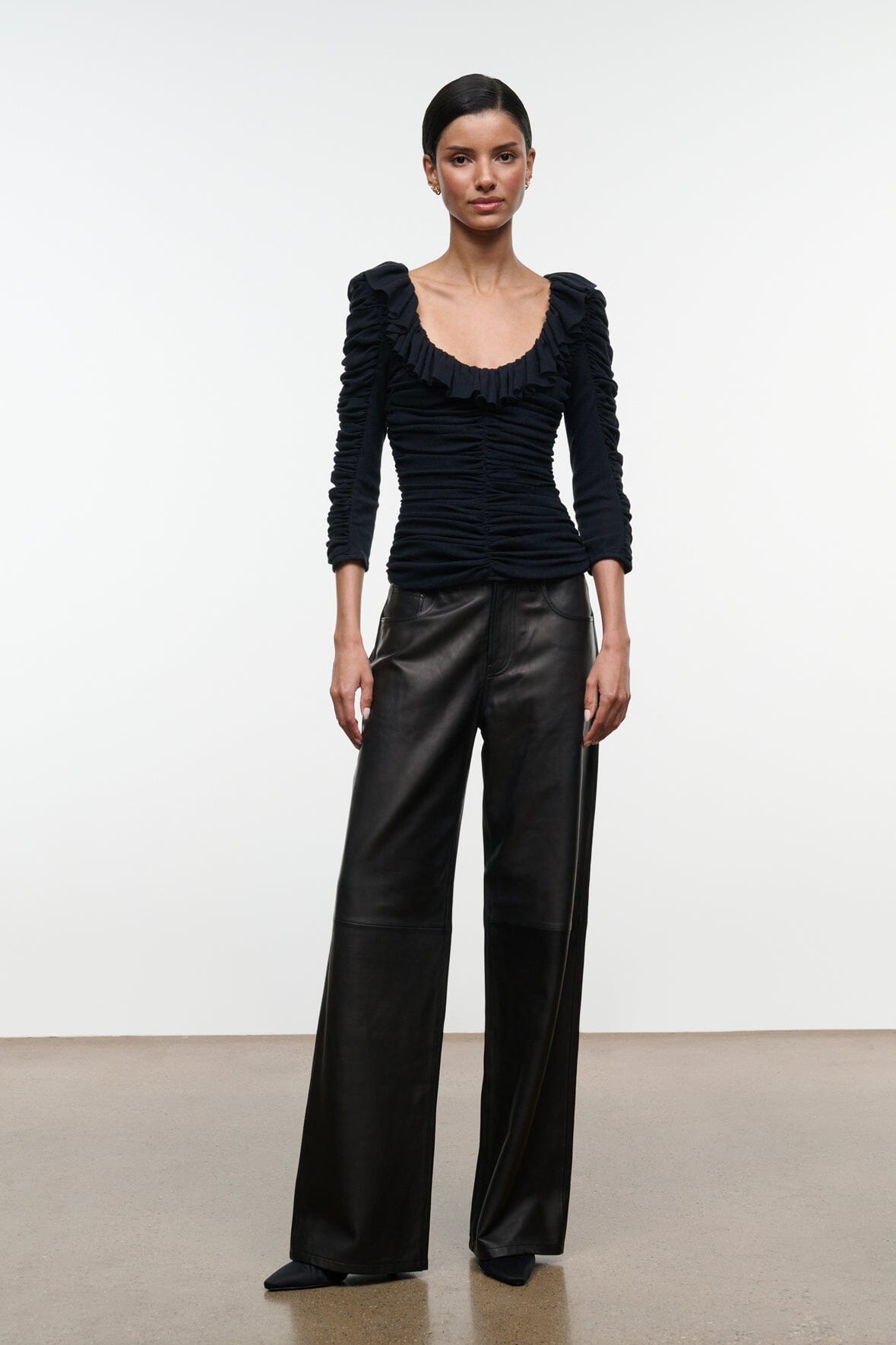 Black ruched off-shoulder top with ruffle sleeves and gathered neckline
