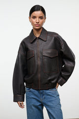 Distressed brown leather bomber-style jacket with zip front, flap pockets, elastic hem