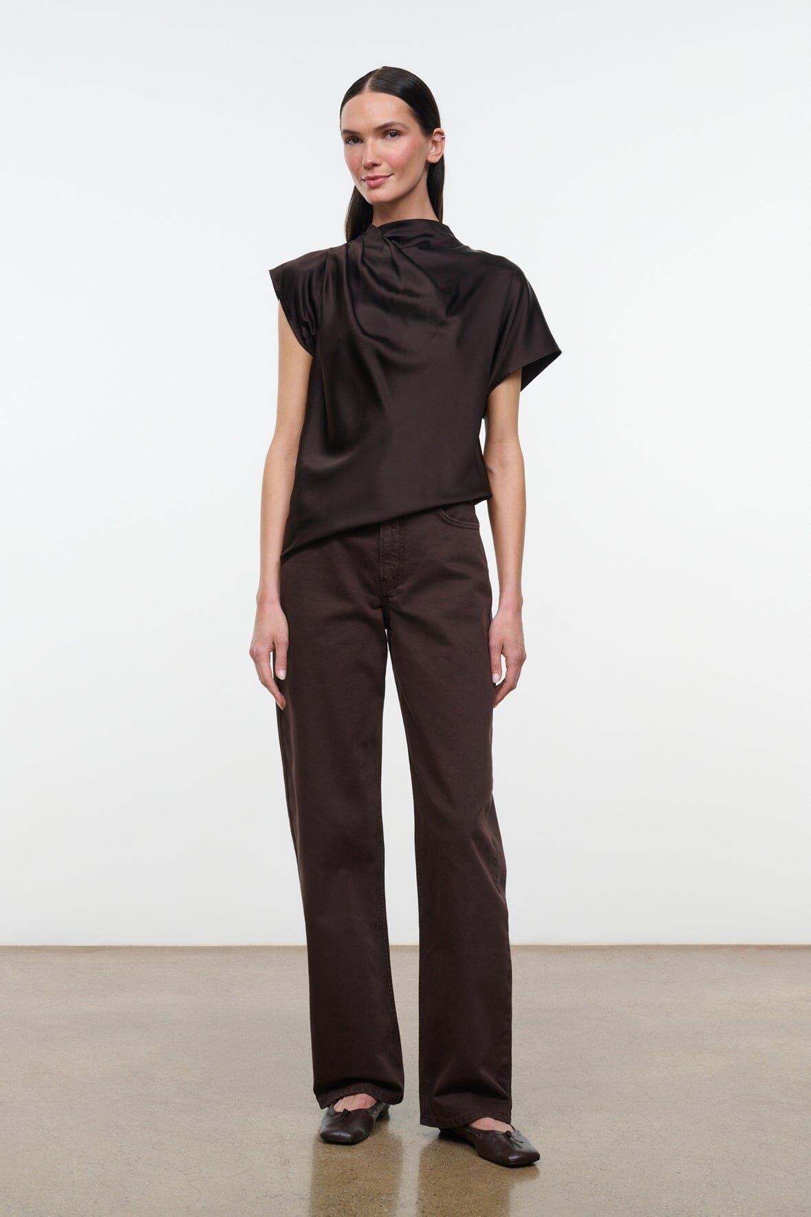 High-rise dark brown jeans with front pockets and relaxed straight fit