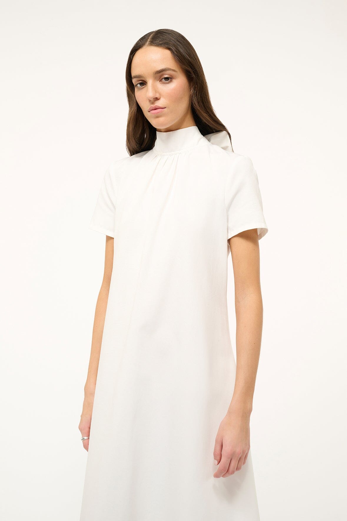 White mock-neck midi dress with short sleeves and subtle front seams