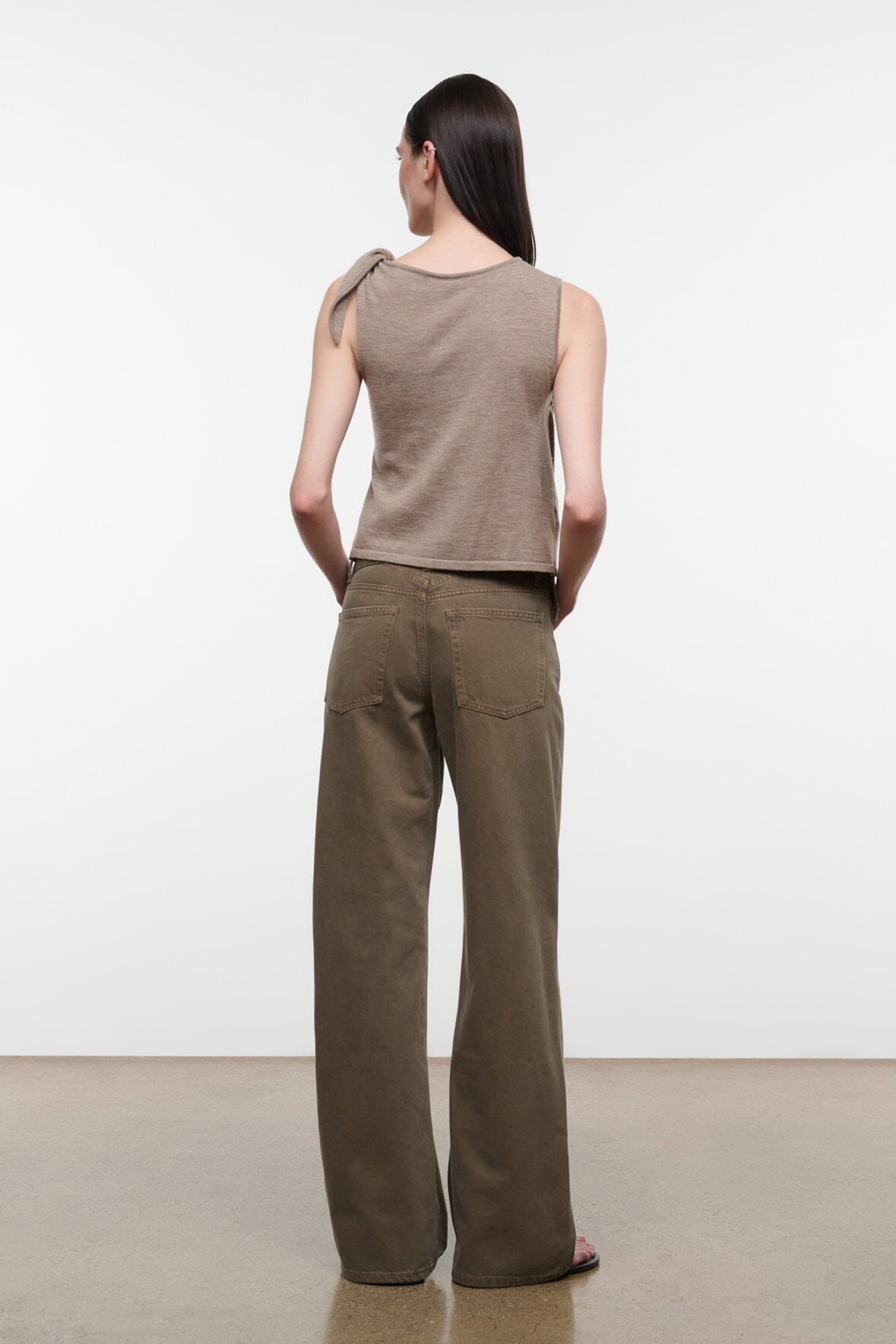 Back view of sleeveless draped top with shoulder tie, sesame beige