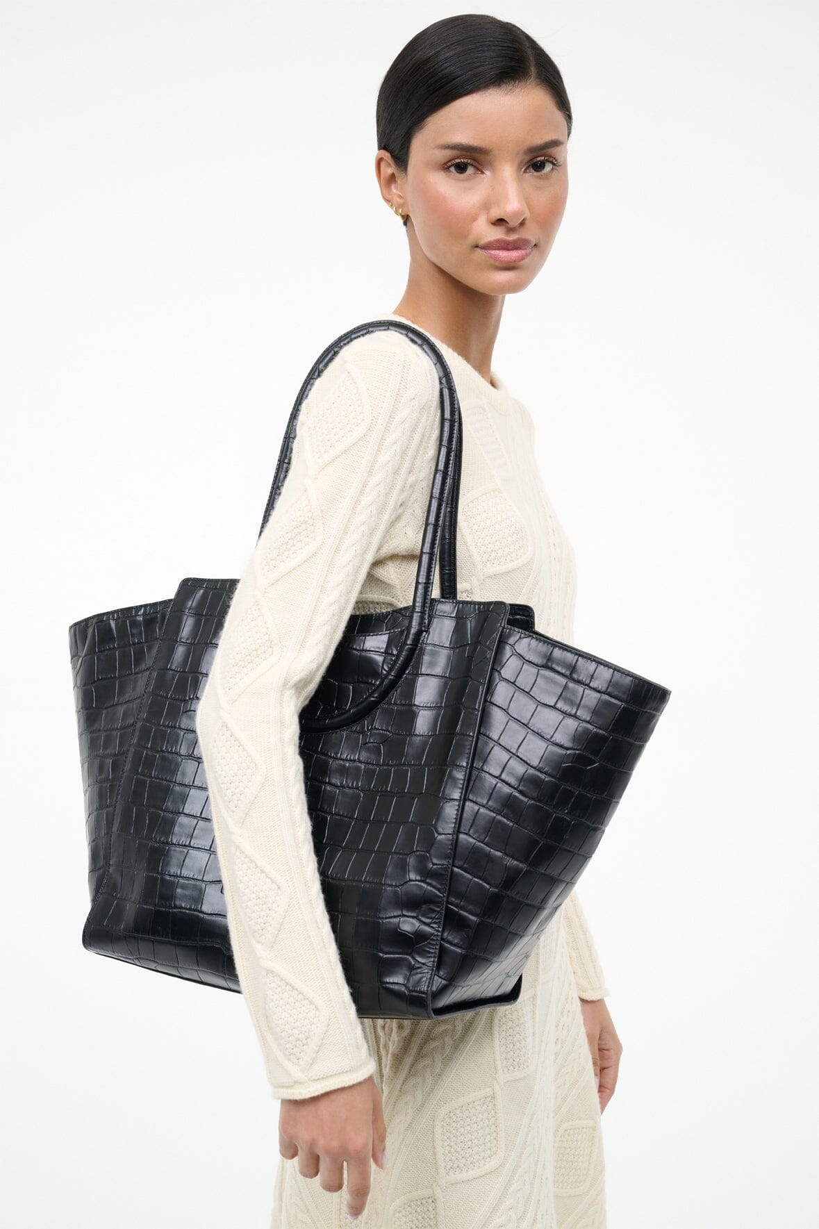 Black croc-effect leather tote bag with curved top handles and roomy size.
