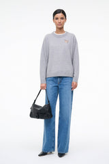 Heather grey cashmere sweater with embroidered dog logo, relaxed fit