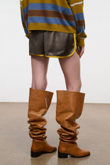 Dark gray shorts with yellow piping, elastic waistband, side tie detail