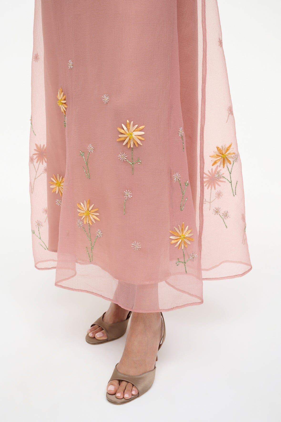 Heeled sandals with blush sheer hem, featuring small yellow flower embroidery