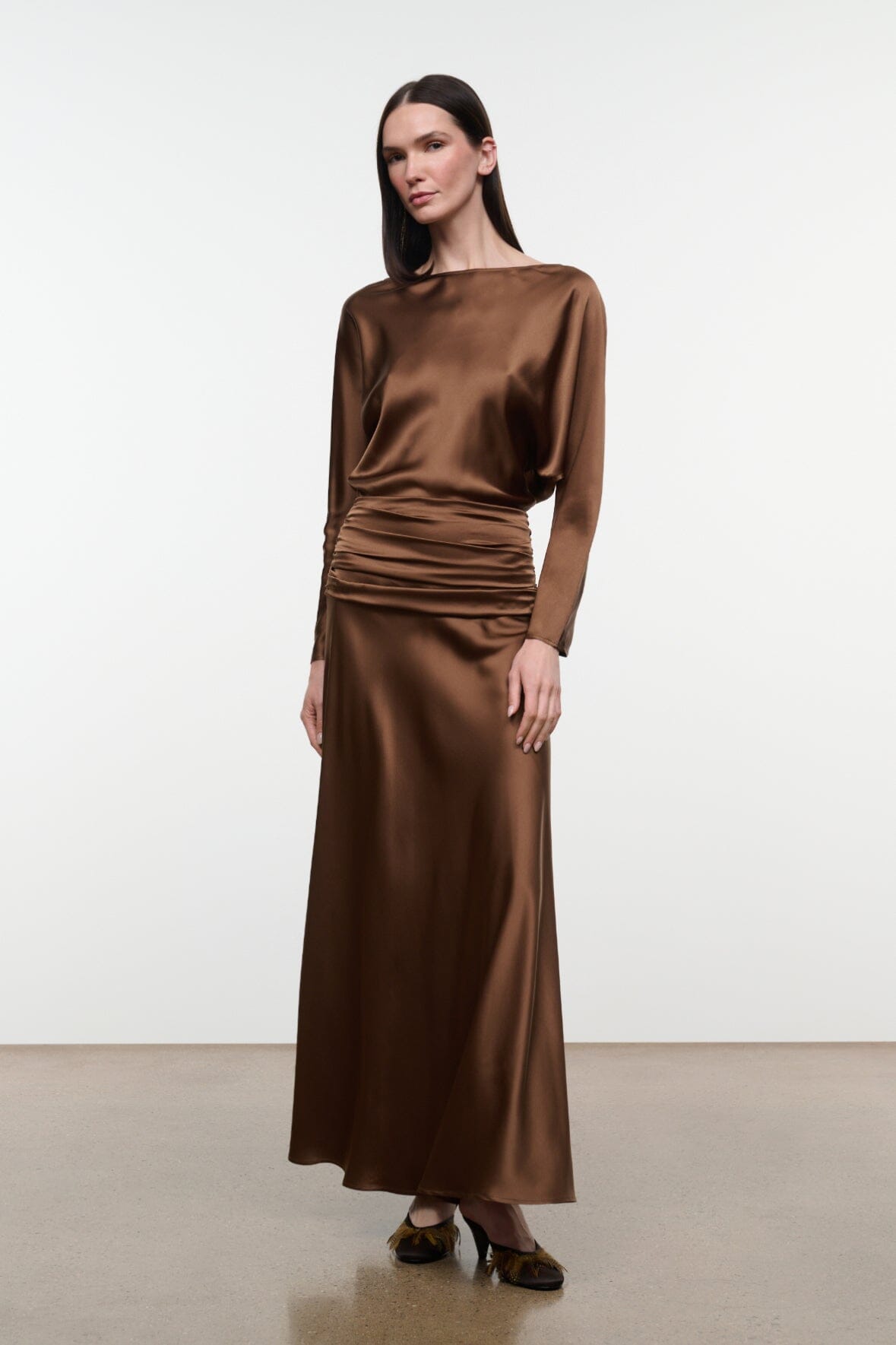 Brown silk dress with long sleeves, crew neckline, ruched waist and full midi skirt