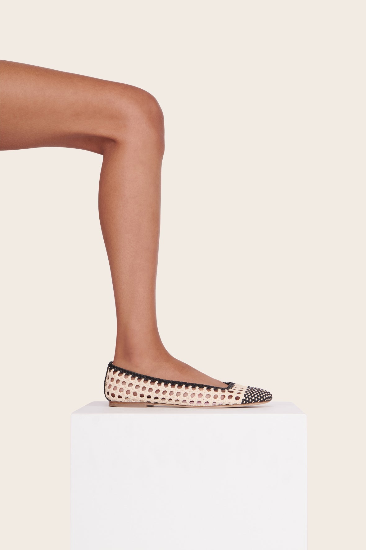 Cream and black crochet ballerina flats, side view with braided trim