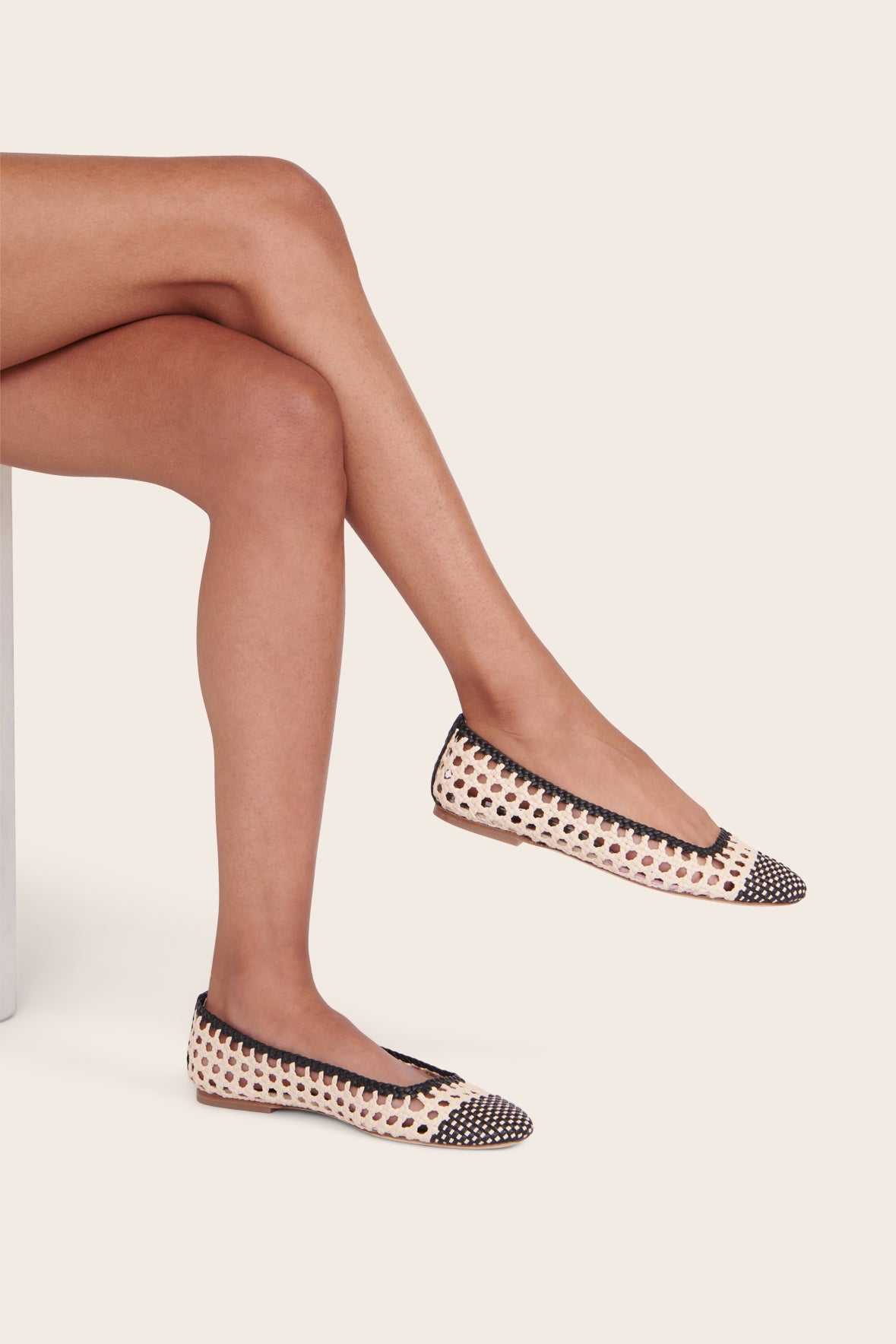 Cream and black crochet ballerina flats with almond toe and woven pattern