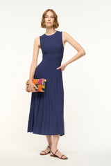 ELYSE navy sleeveless midi dress with high crew neck, pleated skirt, and side clutch