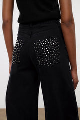 Black jeans with rhinestone-studded front pockets and high-rise waistband