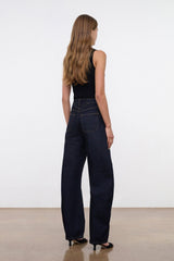 Indigo barrel-leg jeans worn by model, side view