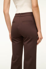 Women's dark chocolate brown pants with mid-rise waistband and front pocket detail.