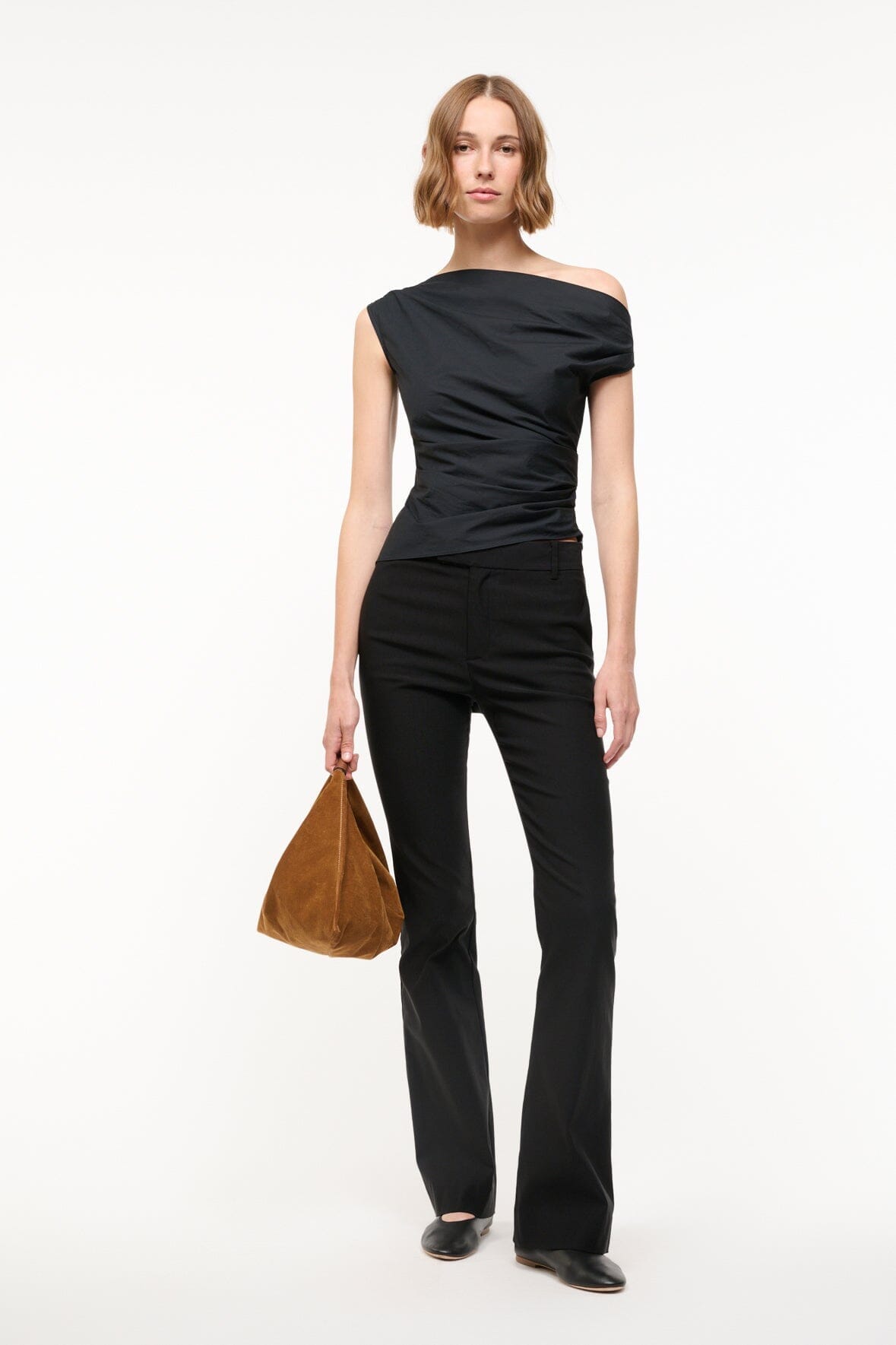 Black off-shoulder draped top with one-shoulder neckline and gathered waist