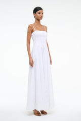 White maxi dress with spaghetti straps and square neckline, pleated skirt, side view