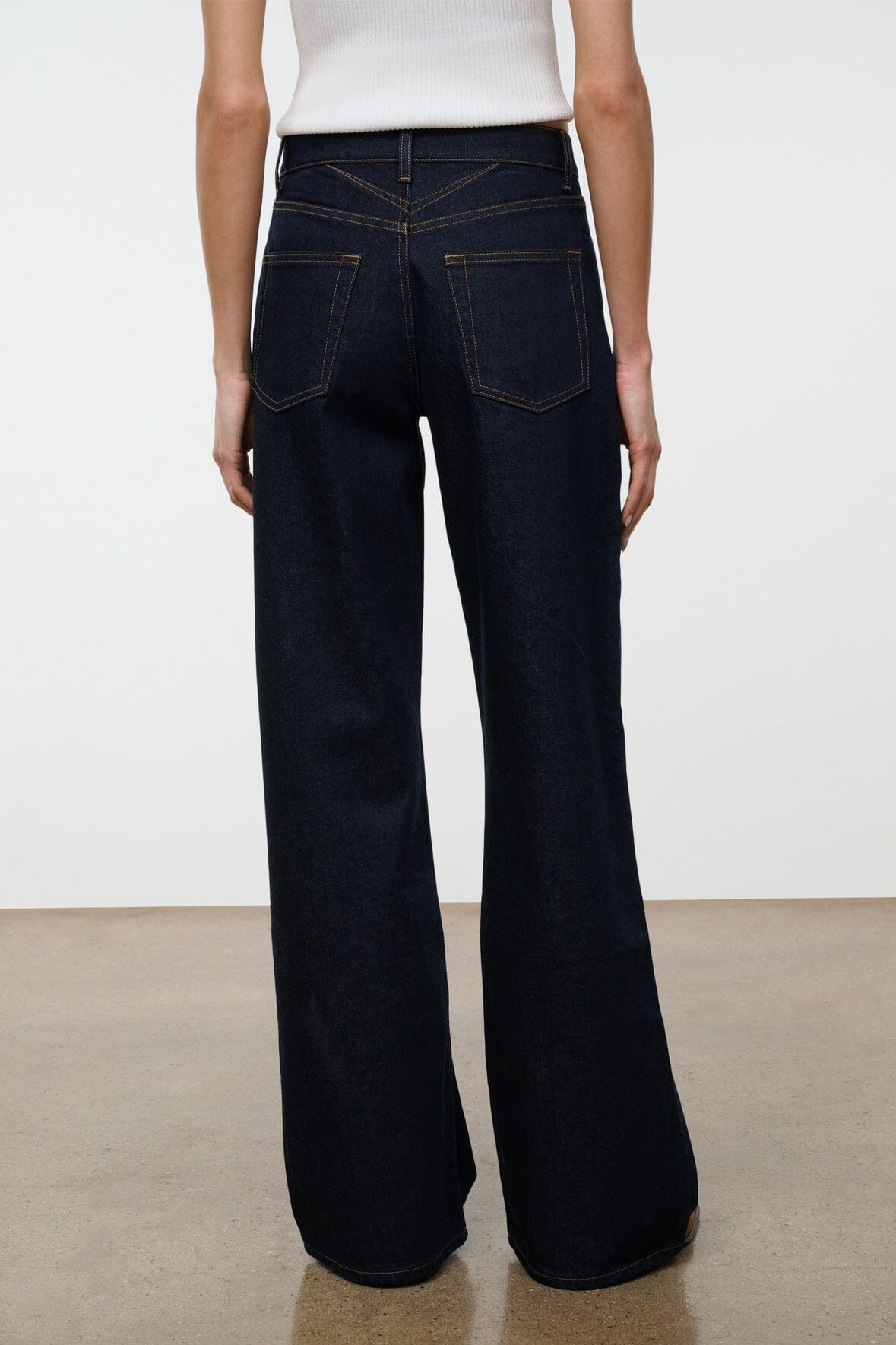 Indigo wide-leg jeans with belt loops, button fly, and front slant pockets.