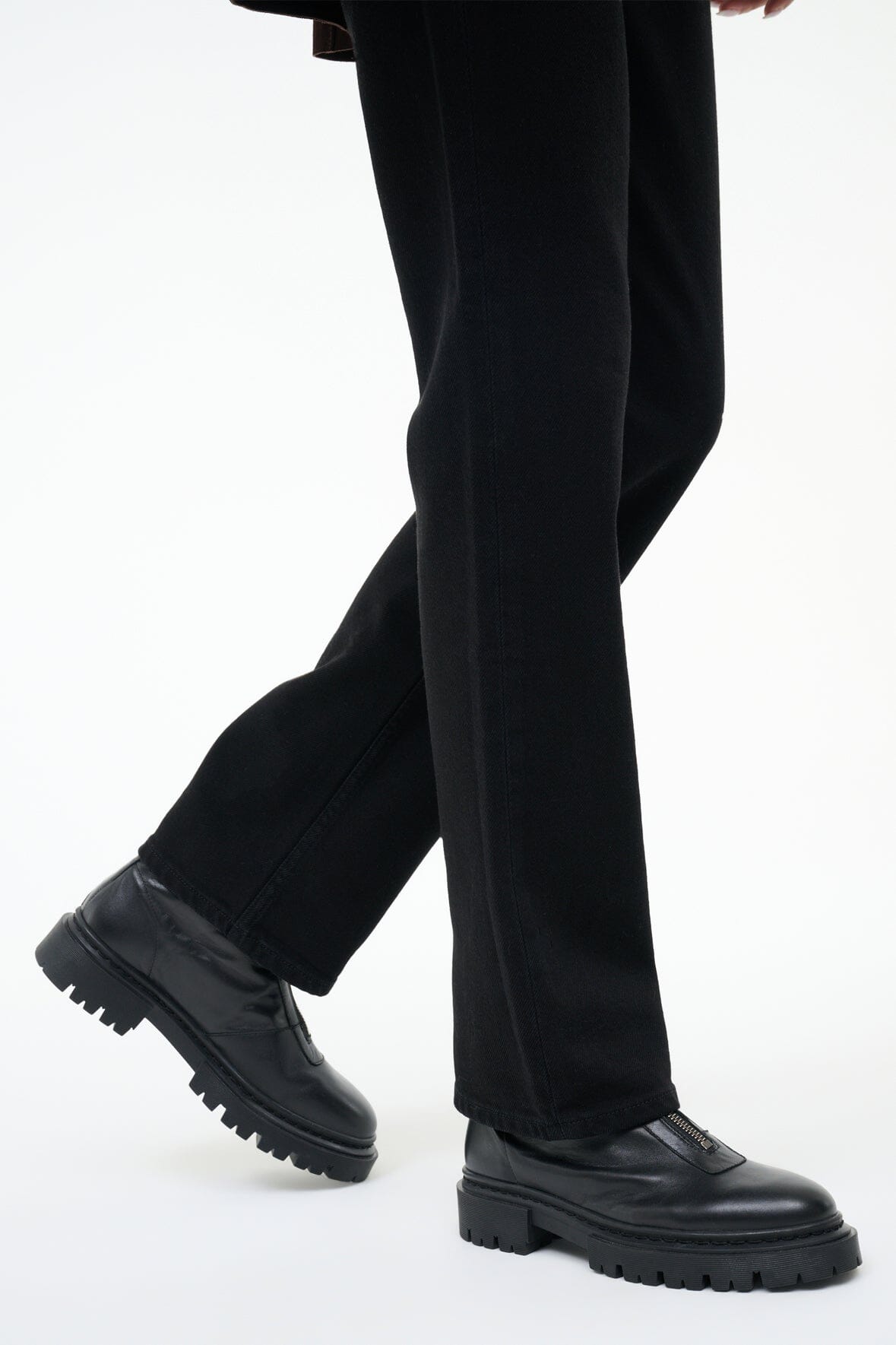 Black ankle boot with chunky lug sole and low-profile side zipper