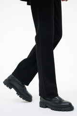 Black ankle boot with chunky lug sole and low-profile side zipper