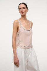 Light pink sleeveless tank top with silver grommet trim along neckline and hem