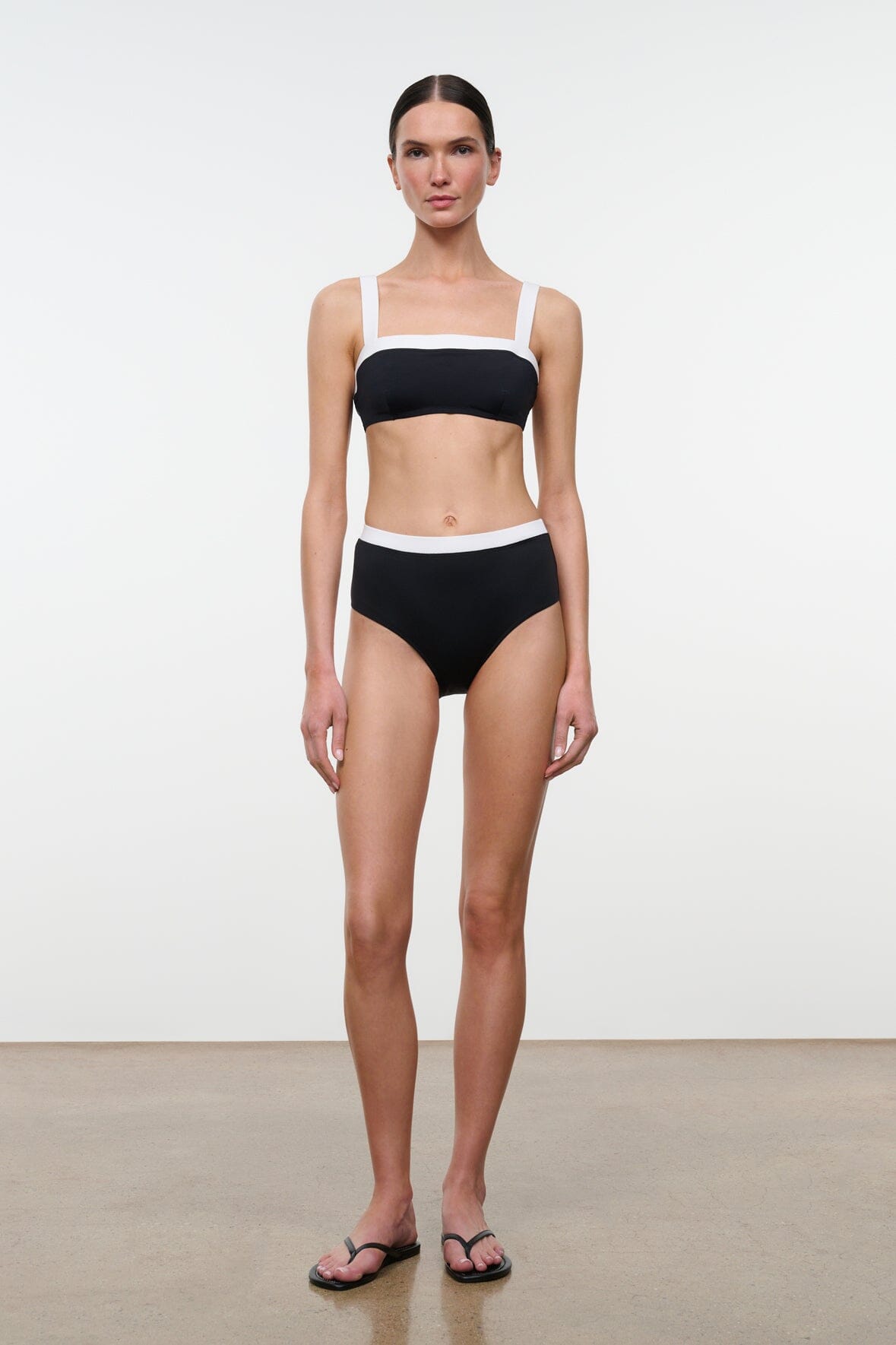 Black bikini top with white-trim underband and thin straps