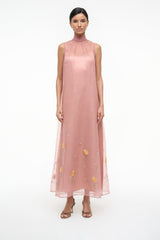 Heeled sandals on a model wearing a blush sleeveless sheer dress with yellow floral embroidery
