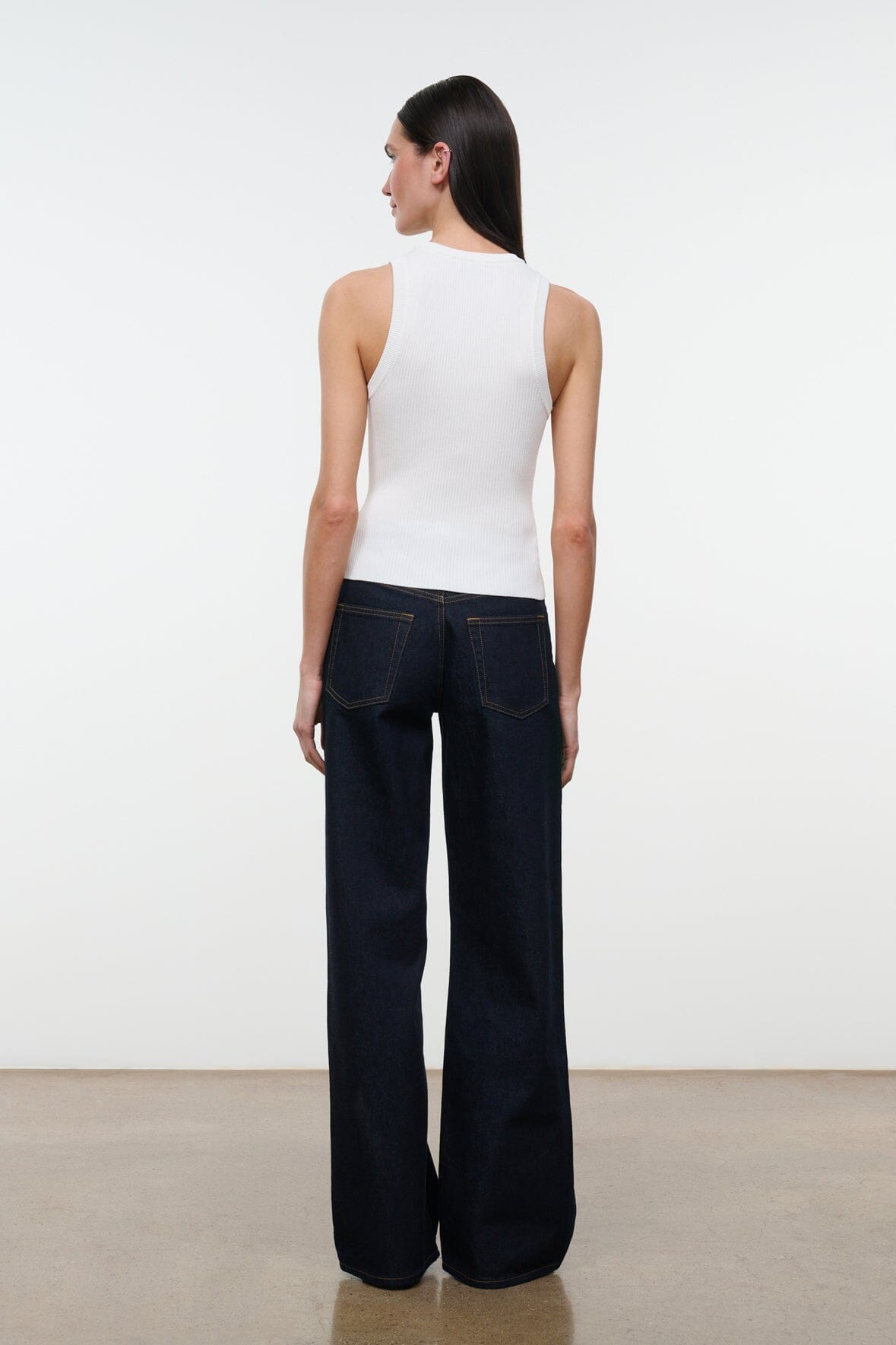 Indigo wide-leg jeans, back view, relaxed straight leg with centered back seam.