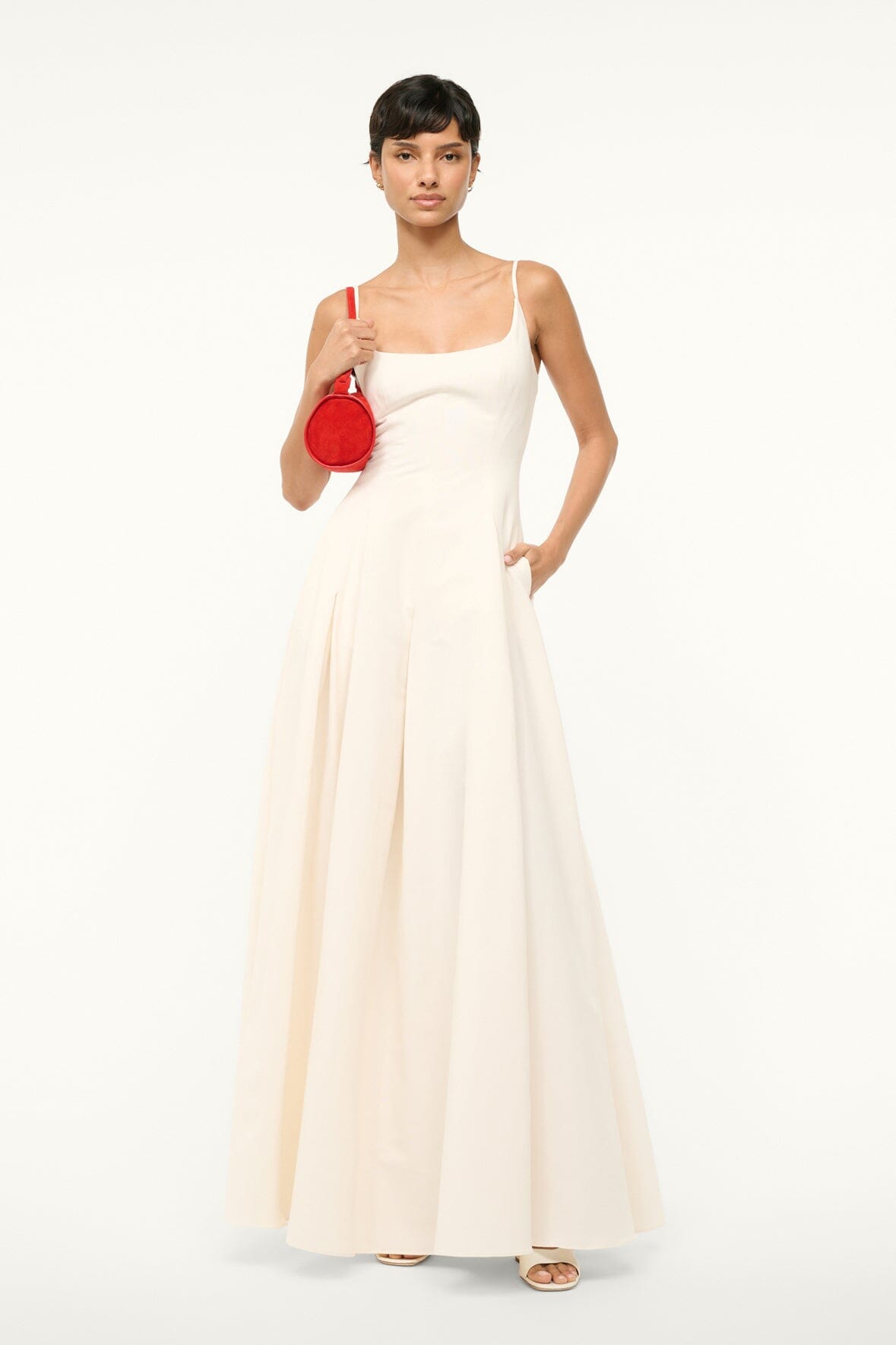 Ivory maxi dress with spaghetti straps, scoop neckline, and full pleated skirt